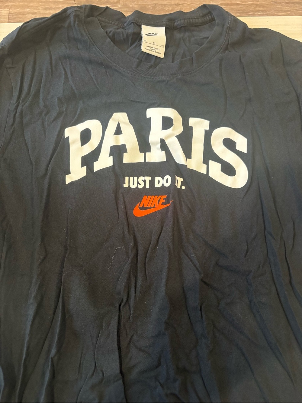 Nike Black Tee with White PARIS Print and Orange Swoosh
